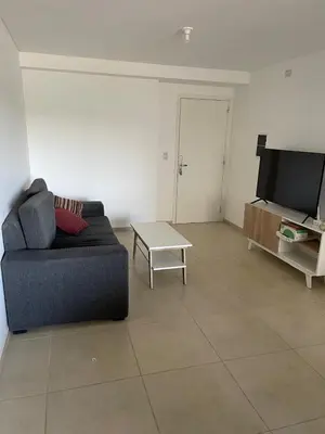 a living room with a couch and a table at Depto 2 Dormitorios Pilay F Temporario in Cordoba