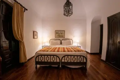 a bedroom with a bed with two lamps on it at Hotel El Potrerillo de Larreta in Alta Gracia