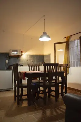 a dining room table and chairs in a kitchen at Tierra de Mariposas in Alta Gracia