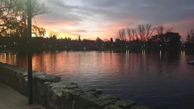 a large body of water with a sunset in the background at Tierra de Mariposas in Alta Gracia