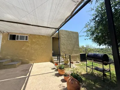 a patio with a tent and some potted plants at vistas del valle in Villa Carlos Paz