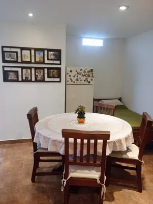 a dining room with a table and chairs and a bed at vistas del valle in Villa Carlos Paz
