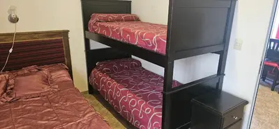 two bunk beds in a room with a bed at Departamento Las Playas in Villa Carlos Paz