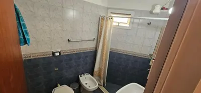 a bathroom with a shower and a toilet and a sink at Departamento Las Playas in Villa Carlos Paz