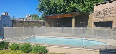 a swimming pool with a fence around it at Departamento Las Playas in Villa Carlos Paz