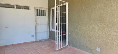 a metal gate on the side of a building at Departamento Las Playas in Villa Carlos Paz