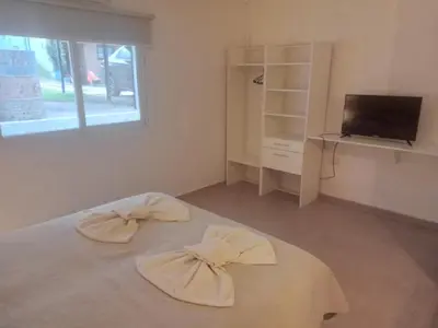 a room with a bed with two bows on it at Apart Centro Zazu in Mina Clavero