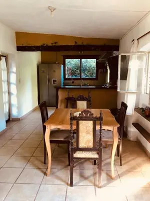 a dining room with a wooden table and chairs at Algarrobo del Valle in San Javier