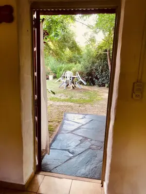 an open door to a yard with a picnic table at Algarrobo del Valle in San Javier