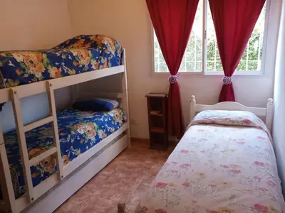 a bedroom with two bunk beds and a small bed at Casa Milan in Villa General Belgrano