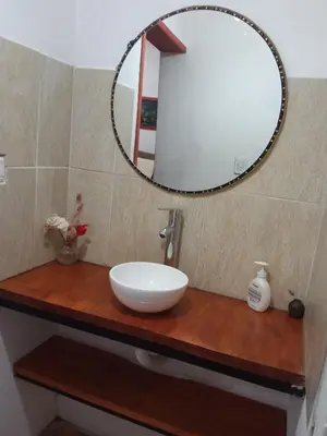 a bathroom with a sink and a mirror at Casa Milan in Villa General Belgrano