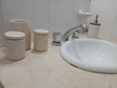a bathroom counter with a white sink and toilets at Depto en Barrio General Paz in Cordoba
