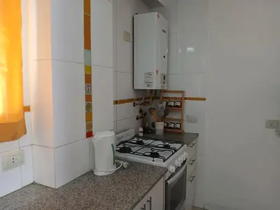 a kitchen with a stove and a counter top at Depto en Barrio General Paz in Cordoba