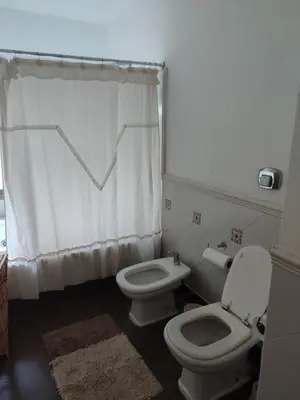 a bathroom with two toilets and a shower curtain at The House you're looking for in Cordoba