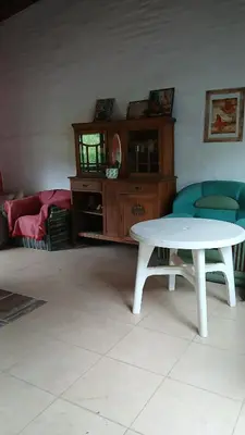 a living room with a white table and chairs at Cabañas Lago Azul in Villa Santa Cruz del Lago
