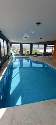 a large swimming pool in a building at Duplex con vista al Lago in Villa Carlos Paz