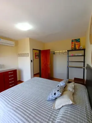 a bedroom with a bed and a ladder in it at Duplex con vista al Lago in Villa Carlos Paz