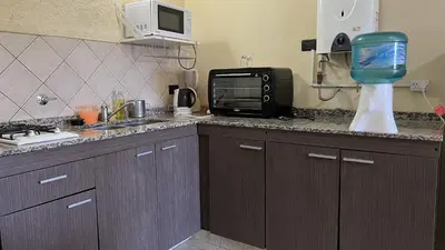 a kitchen with a counter with a microwave and a sink at Duplex con vista al Lago in Villa Carlos Paz