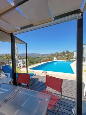 a view from the deck of a villa with a swimming pool at Duplex con vista al Lago in Villa Carlos Paz