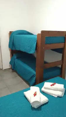a room with a bunk bed with towels on a table at Departamento CR in Alta Gracia