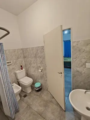 a bathroom with a toilet and a sink at Departamento CR in Alta Gracia