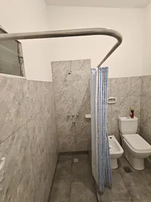 a bathroom with a shower with a toilet and a sink at Departamento CR in Alta Gracia
