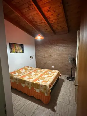a bedroom with a bed in a room at Cabañas las marias 3 in Tanti Nuevo