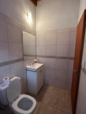 a small bathroom with a toilet and a sink at Cabañas las marias 3 in Tanti Nuevo