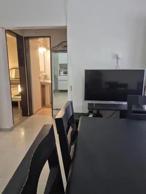 a living room with a black table and a television at Apartamento en Villa Carlos Paz in Villa Carlos Paz