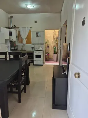 a kitchen with a dining table and a stove at Apartamento en Villa Carlos Paz in Villa Carlos Paz