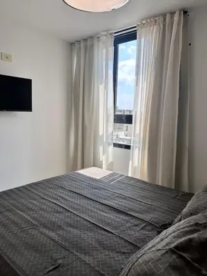 a bedroom with a bed and a large window at Departamento Premium con hermosos atardeceres in Cordoba
