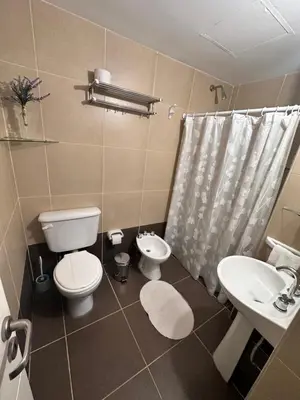 a bathroom with a toilet and a sink and a shower at Departamento Premium con hermosos atardeceres in Cordoba