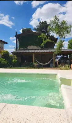 a house with a swimming pool in front of a house at Mirian house in Villa Carlos Paz