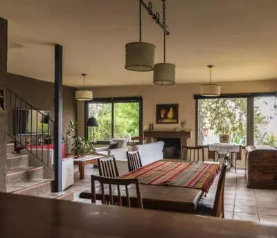 a large living room with a table and chairs at Mirian house in Villa Carlos Paz