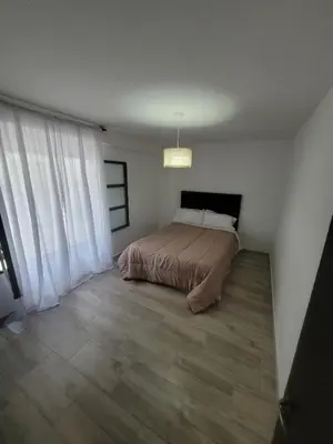 a bedroom with a bed in the corner of a room at Strategic place, close to everything in Villa Carlos Paz