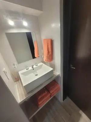 a bathroom with a white sink and a mirror at Strategic place, close to everything in Villa Carlos Paz