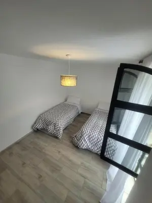 two beds in a room with a window at Strategic place, close to everything in Villa Carlos Paz