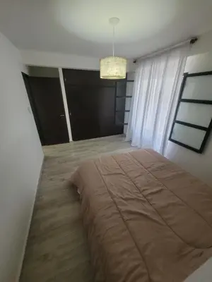 a bedroom with a large bed and a chandelier at Strategic place, close to everything in Villa Carlos Paz
