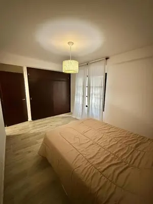 a bedroom with a bed and a chandelier at Strategic place, close to everything in Villa Carlos Paz