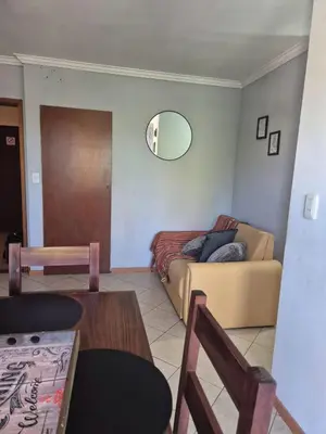 a living room with a couch and a table at LUMINOSO Y COMPLETO DEPARTAMENTO CENTRO Villa Carlos Paz in Villa Carlos Paz