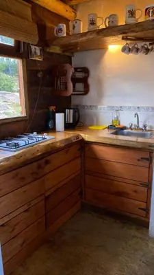 a kitchen with a sink and a counter top at Cabañas Aldea Lucerna La Cumbrecita in La Cumbrecita