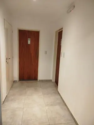 an empty room with a door and a tile floor at Apart Center in Río Cuarto