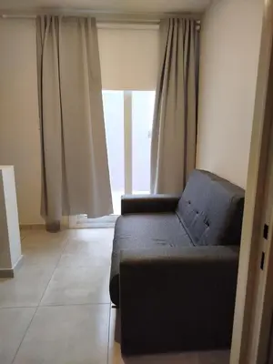 a living room with a couch and a window at Apart Center in Río Cuarto