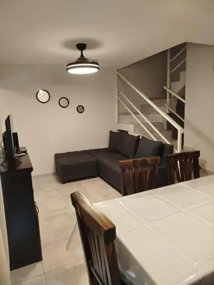 a living room with a couch and a table and chairs at Apart Center in Río Cuarto