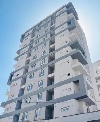 a tall white apartment building with the sky in the background at Apart Center in Río Cuarto