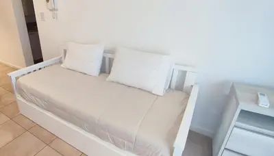 a white bed with two pillows on top of it at Rincón Córdoba in Cordoba