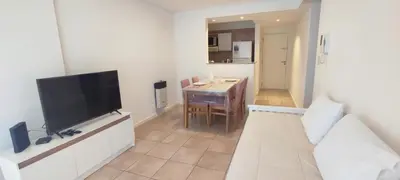 a living room with a television and a dining room at Rincón Córdoba in Cordoba