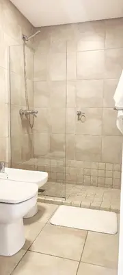 a bathroom with a shower and a toilet and a sink at Rincón Córdoba in Cordoba