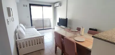 a room with a kitchen with a table and a television at Rincón Córdoba in Cordoba