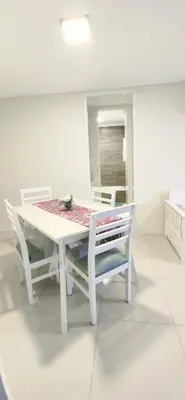 a white dining room table with two chairs and a table and a table and chairs at Skyline Córdoba in Cordoba